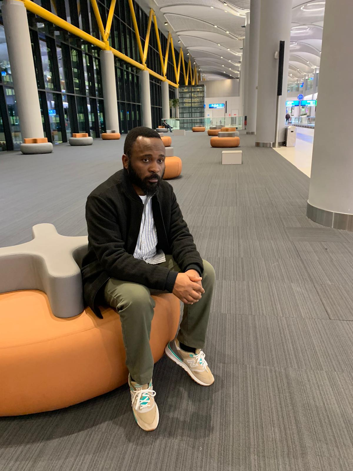 Adeola seated in a modern architectural space